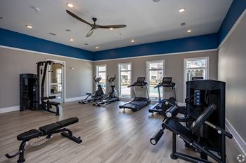 a gym with exercise equipment and windows